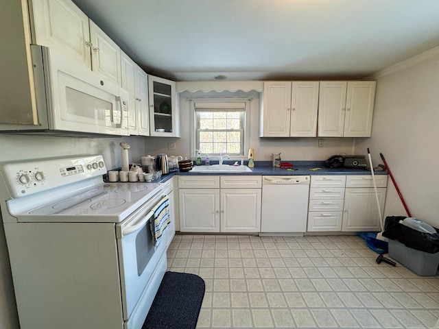 kitchen featuring white cabinetry, white appliances, and sink