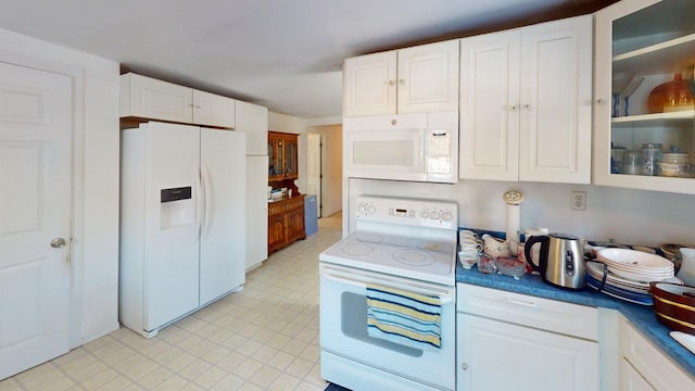 kitchen with white cabinets and white appliances