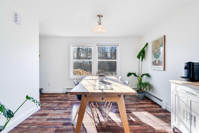 dining space featuring a baseboard radiator and dark hardwood / wood-style floors