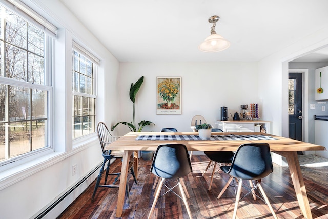 dining space with dark hardwood / wood-style floors and a baseboard radiator