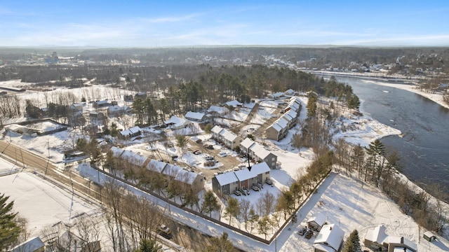 snowy aerial view with a water view