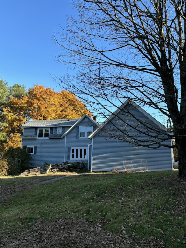 view of side of home featuring a yard