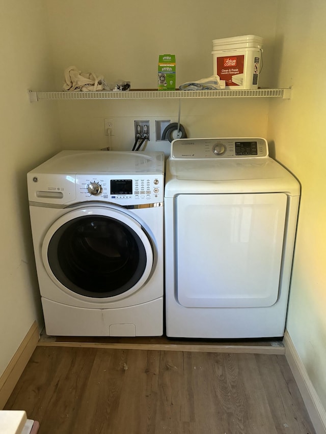 washroom featuring dark hardwood / wood-style flooring and washer and dryer