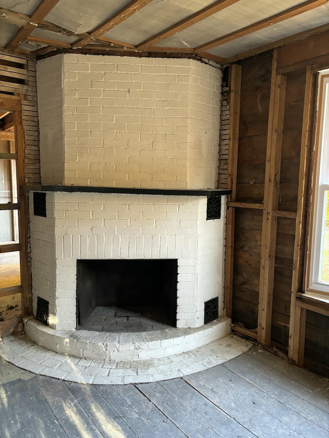 room details with wood-type flooring and a brick fireplace