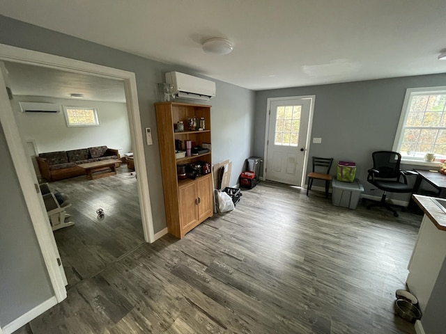 home office featuring an AC wall unit and hardwood / wood-style floors