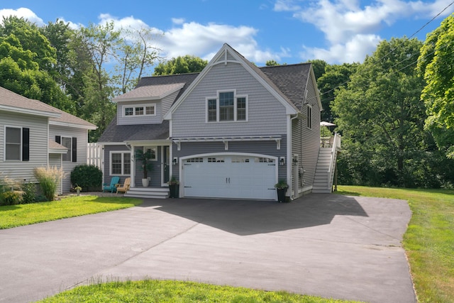 view of front of home with a front lawn and a garage