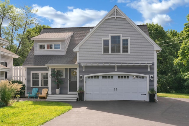 view of front of property featuring a front lawn and a garage