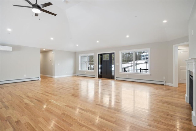 unfurnished living room with light wood-style floors, a fireplace, and a baseboard heating unit