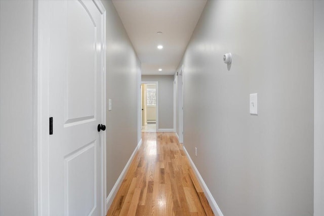 hallway featuring recessed lighting, light wood-style flooring, and baseboards