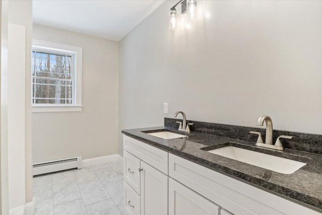 bathroom with marble finish floor, baseboards, a baseboard heating unit, and a sink