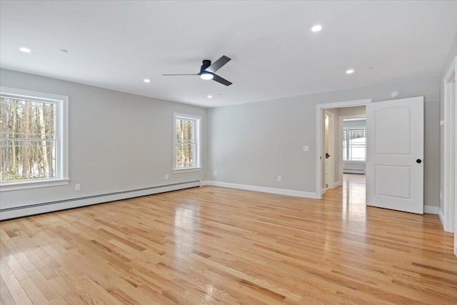 unfurnished room featuring light wood finished floors, baseboards, ceiling fan, a baseboard heating unit, and recessed lighting