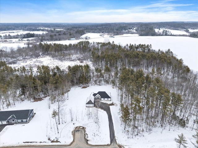 snowy aerial view with a forest view