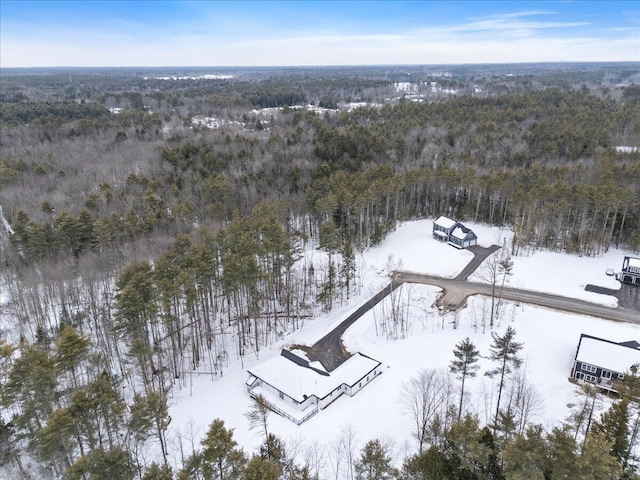 snowy aerial view with a forest view