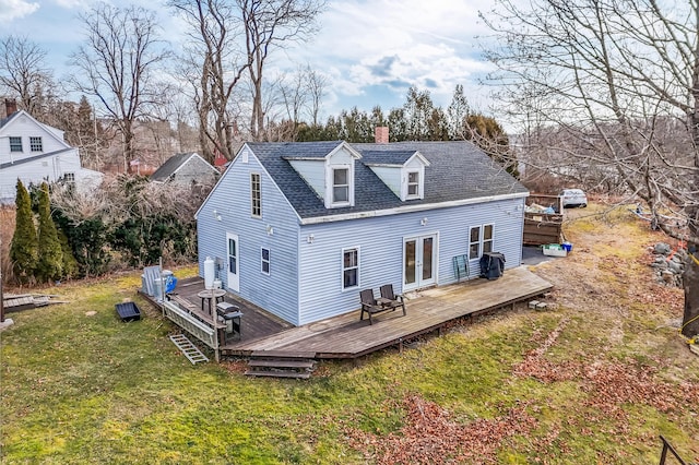 rear view of property featuring french doors, a lawn, and a wooden deck