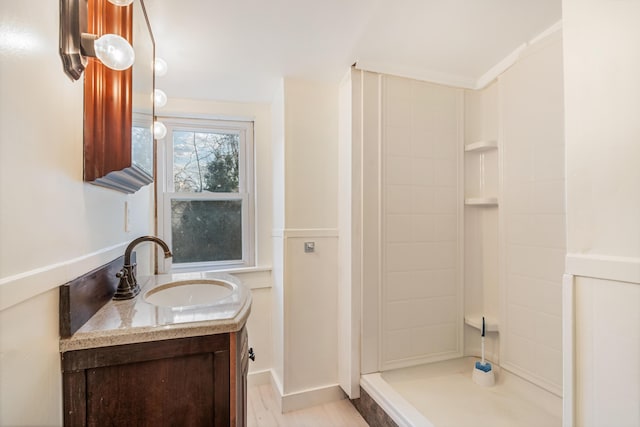 bathroom featuring a shower and vanity