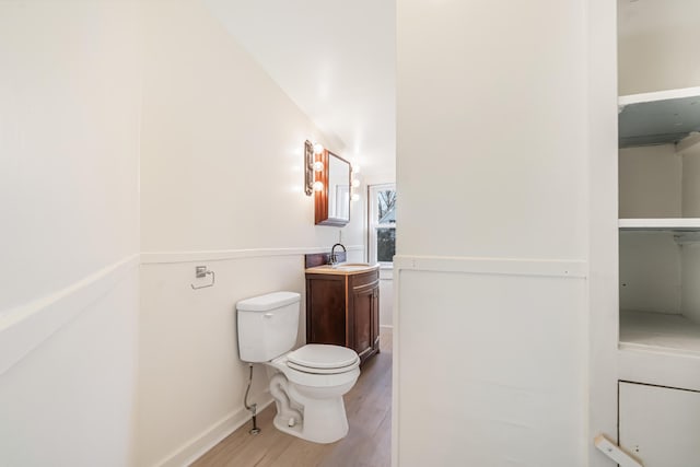 bathroom featuring hardwood / wood-style floors, vanity, and toilet