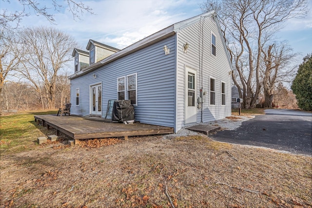 view of home's exterior with a wooden deck