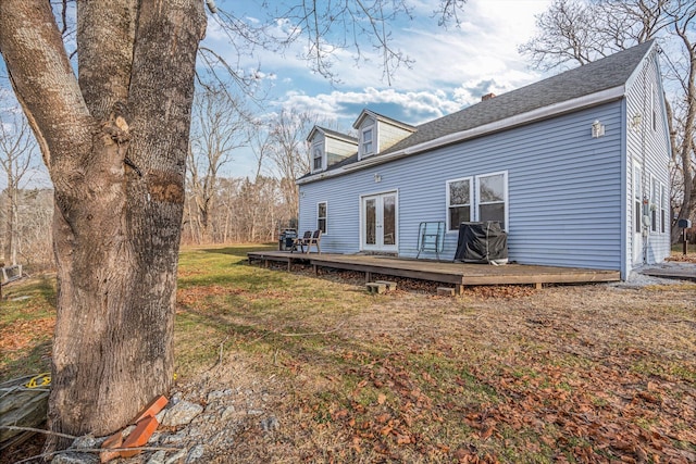 back of house featuring a yard and a deck