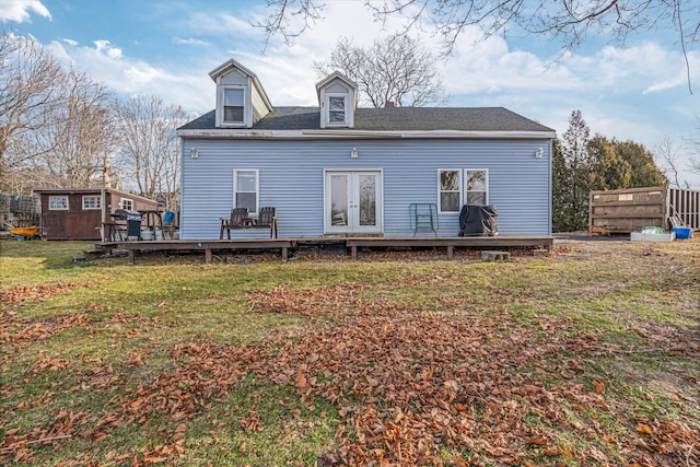 rear view of property featuring a yard, a shed, and a deck