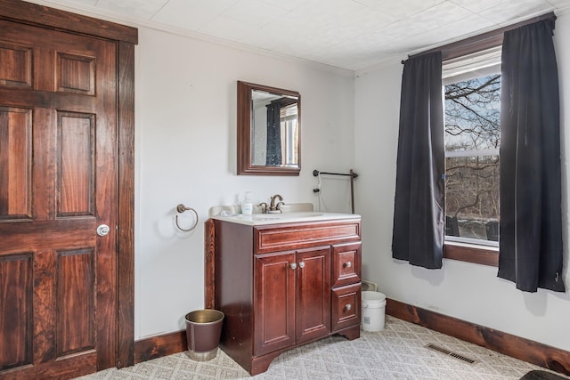 bathroom with vanity and ornamental molding