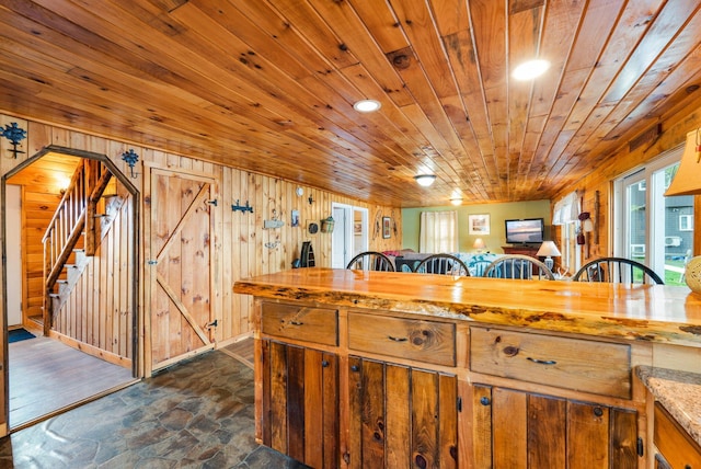 13 W Orchard Ln, Swanville, ME 04915 - kitchen featuring dark stone finish flooring, wood ceiling, wood walls, open floor plan, and wood counters