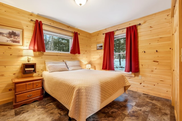 bedroom with wooden walls and multiple windows