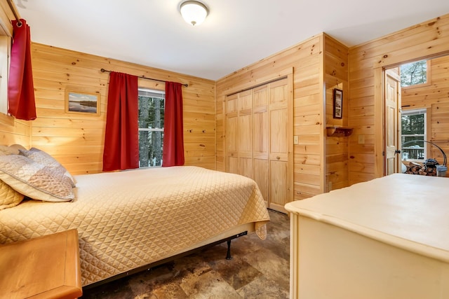 bedroom with wood walls and a closet