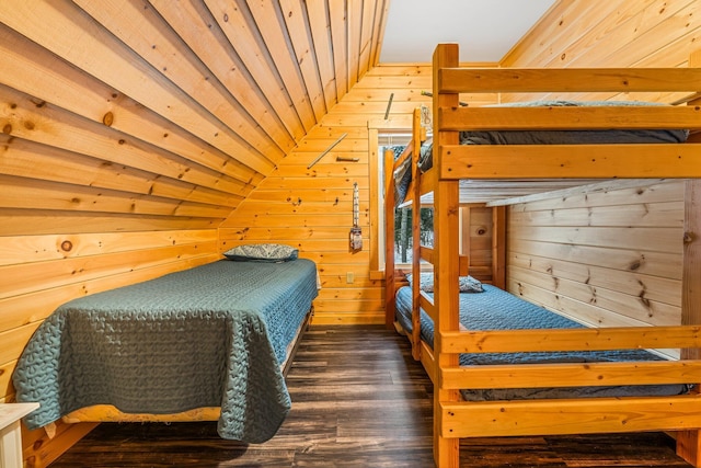 bedroom with wooden ceiling, dark wood-type flooring, wooden walls, and vaulted ceiling