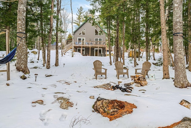 yard covered in snow featuring a deck