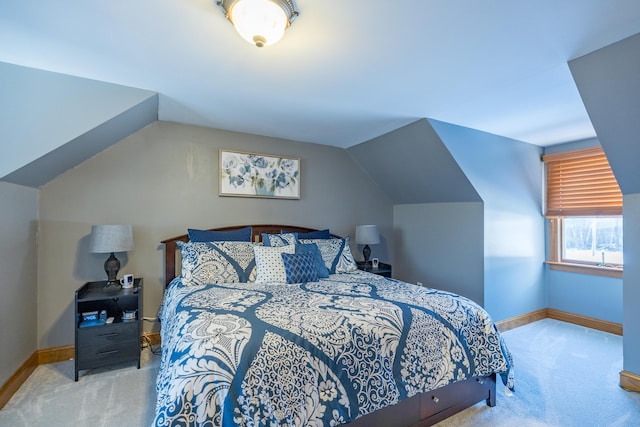 bedroom featuring light carpet and vaulted ceiling