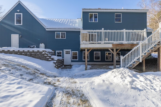 snow covered property featuring a wooden deck