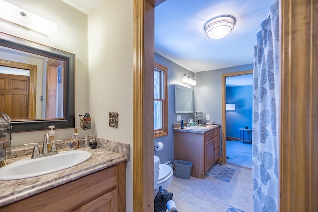 bathroom featuring vanity and toilet