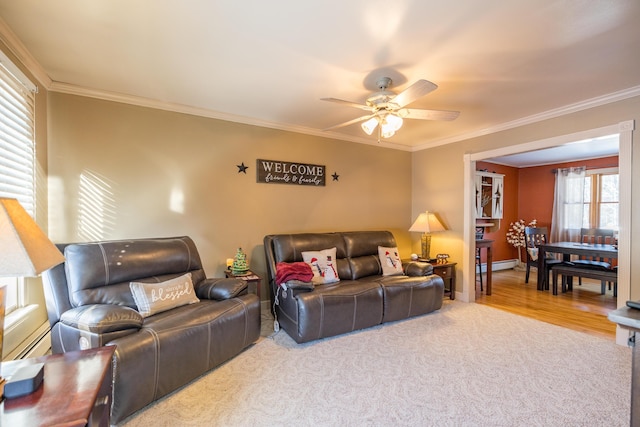 living room featuring carpet flooring, ornamental molding, ceiling fan, a baseboard radiator, and plenty of natural light