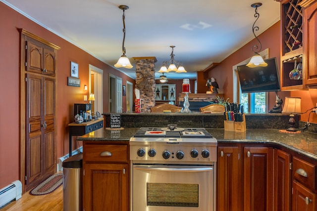 kitchen with stainless steel range, an inviting chandelier, a baseboard heating unit, light hardwood / wood-style floors, and pendant lighting