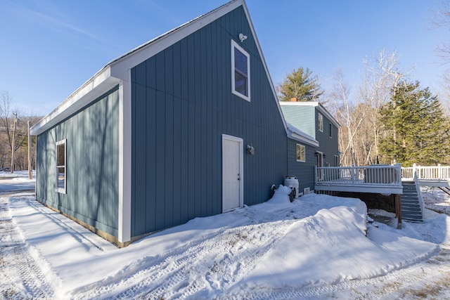 snow covered property with a wooden deck