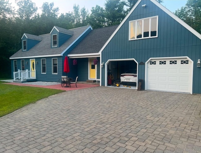 view of front of home with a garage and a patio