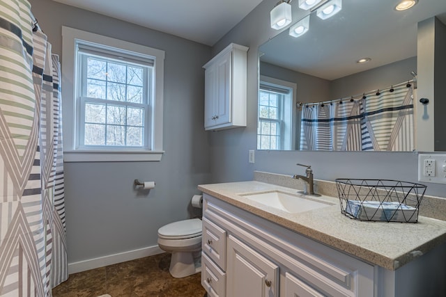 bathroom featuring vanity and toilet