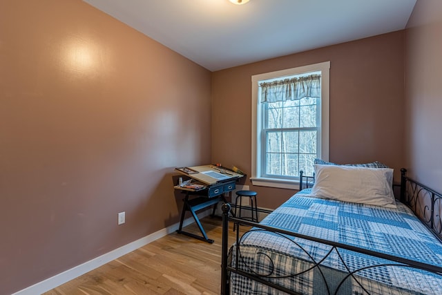 bedroom featuring light hardwood / wood-style floors and baseboard heating