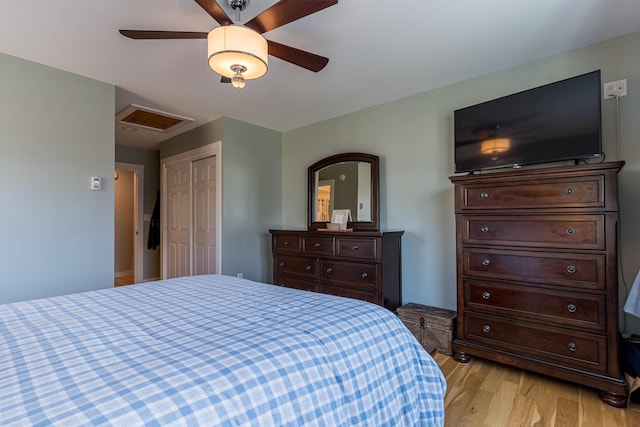 bedroom featuring ceiling fan, a closet, and light hardwood / wood-style flooring