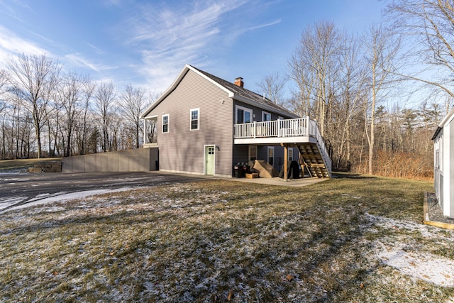 back of property featuring a yard and a deck