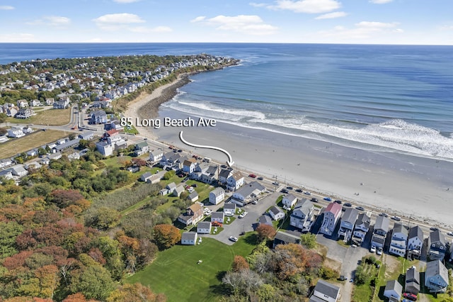 drone / aerial view with a residential view, a water view, and a view of the beach