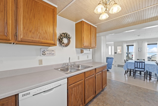 kitchen featuring a sink, a wealth of natural light, white dishwasher, and light countertops