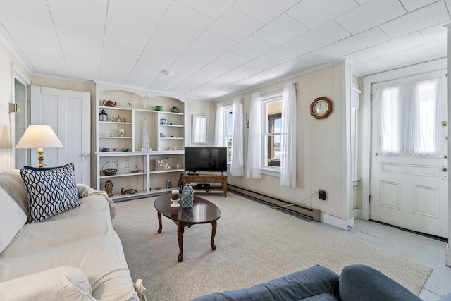 living room featuring built in features, ornamental molding, and a baseboard radiator