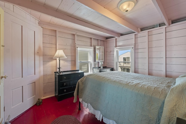 bedroom with wooden walls and beamed ceiling