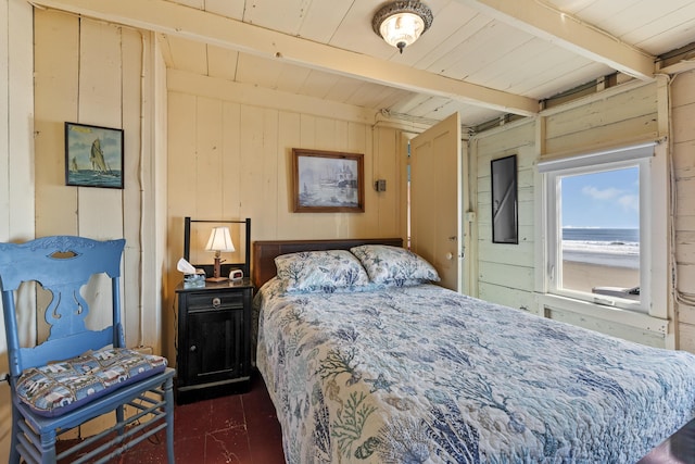 bedroom with beamed ceiling, wood ceiling, and wood walls