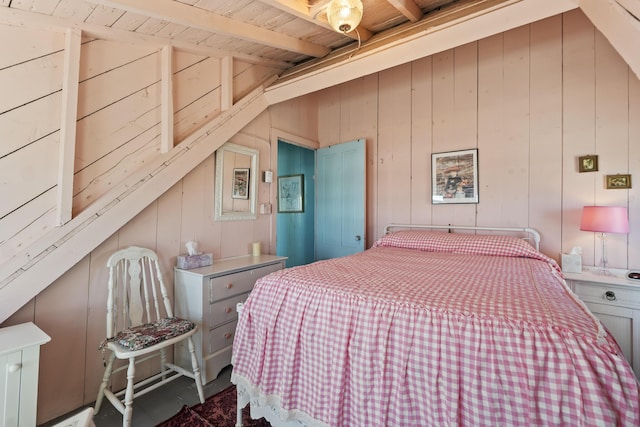 bedroom featuring vaulted ceiling with beams, wood walls, and wood ceiling