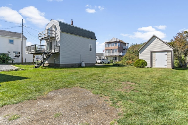 view of home's exterior with stairway, a gambrel roof, a shed, a lawn, and an outdoor structure