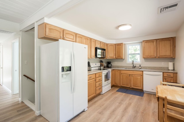 kitchen featuring white appliances, light hardwood / wood-style floors, sink, and light brown cabinets