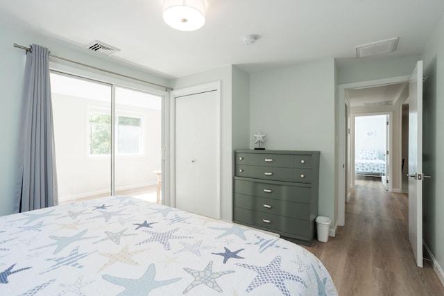 bedroom with a closet and dark hardwood / wood-style floors