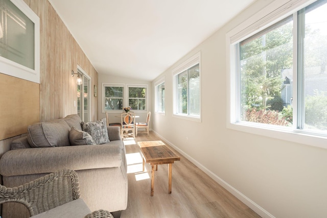 sunroom / solarium with lofted ceiling and a healthy amount of sunlight